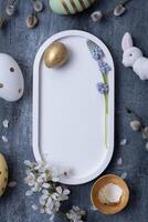 Easter composition with flowers, white rabbit and eggs flat lay, top view. Copy space. photo