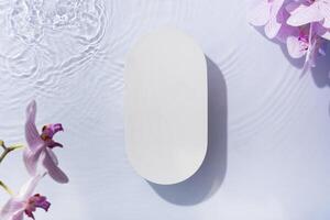 Summer cosmetic template, mockup. Empty podium or pedestal of water ripples and orchis flat lay, top view photo