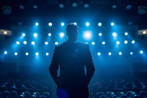 AI generated Rear view of a businessman standing in front of the empty hall. The concept of performing on stage, public speaking photo