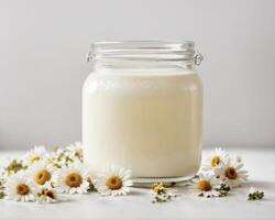 AI generated Glass of milk and chamomile on white background photo
