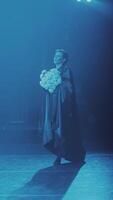 the soloist, ballet dancer, dances during the performance with a bouquet of flowers. Vertical format for the phone. video