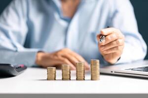 Woman with coin stack. Financial Growing savings concept. Saving money by hand putting coins money accounting planning. photo