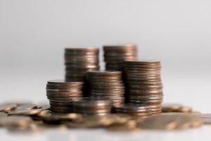 Stacked coins on white background. Investment concept photo