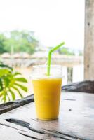 mango smoothies in take away glass photo
