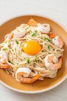 spaghetti white cream sauce with shrimps and egg yolk photo