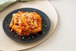 Rigatoni pasta bolognese with cheese photo