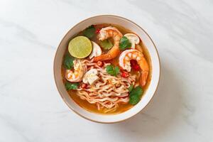 instant noodles ramen in spicy soup with shrimps or Tom Yum Kung photo