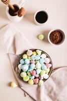 Sweet small meringues for dessert on a plate on the table top and vertical view photo