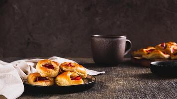 Appetizing envelopes with cheese and pepperoni sausage on a plate on the table web banner photo