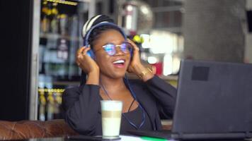 A young black woman using a laptop for studying, watching online lectures, workshops and master classes. Video chat job interview or distance language course class concept