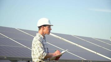 Engineer checks solar panels productivity. The green energy concept video