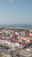 Vertical Video of Costa Nova Do Prado in Portugal, street with colorful and striped houses