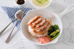 Roasted duck with steam rice, vegetable and pickled ginger on white background as traditional Chinese food photo