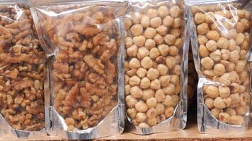 many mixed nuts in a plastic packet on shelf video