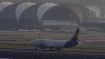 BANGKOK, THAILAND - MARCH 02, 2023. Boeing 737, HS-KMA of K-Mile Air take off at Suvarnabhumi airport, sunset time. Express airline, cargo plane departure video