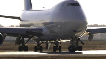 NOVOSIBIRSK, RUSSIAN FEDERATION - OCTOBER 20, 2021. Cargo jet Boeing 747 of ASL Airlines taxiing at Tolmachevo airport, middle shot, side view. Airplane in backlight video