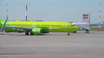 SAINT PETERSBURG, RUSSIA - JULY 26, 2022. Passenger aircraft Boeing 737, RA-73360 of S7 Airlines taxiing at Pulkovo airport, apron, airfield video
