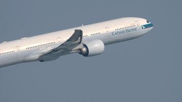 HONG KONG - NOVEMBER 09, 2019. Aircraft Boeing 777 of Cathay Pacific taking off and climbing at Hong Kong airport. Passenger flight departure, side view. Airplane in the sky. video