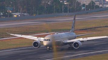 PHUKET, THAILAND - FEBRUARY 23, 2023. Boeing 787, A6-BLU of Etihad Airways braking after landing at Phuket airport. Dreamliner aircraft on the airfield. Airplane arriving. Spoilers up video