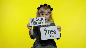 Child girl showing Black Friday and Up To 70 Percent Off advertisement banners. Low prices, shopping video