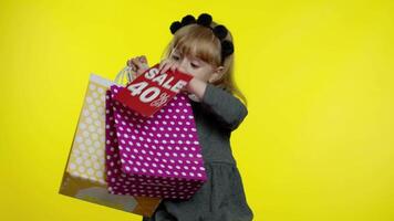 Pupil girl with shopping bags showing Up To 40 percent Off banner text advertisement. Holiday sale video