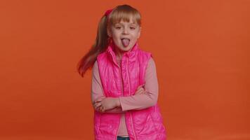 Funny girl kid showing tongue making faces at camera, fooling around, joking, aping with silly face video