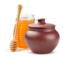 Clay Honey pot and glass jar isolated on white background photo