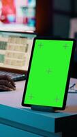 Vertical Video African american business student looking at isolated greenscreen, examining academic software spreadsheet to learn about tax services. Girl using tablet with blank copyspace layout. Camera A.