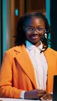 Vertical Video Portrait of university student sitting at her home desk using laptop to do school tasks. Young woman exploring career pathways and networking opportunities through professional platforms. Camera A.