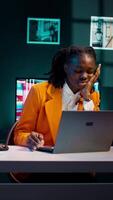 Vertical Video Student working under pressure to finish homework at midnight, trying to respect deadline. Girl rubbing eyes and solving tasks while feeling exhausted, dealing with burnout syndrome. Camera B.