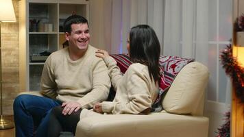 Caucasian man with matching clothes with her girlfriend giving her a surprise gift on christmas day. video