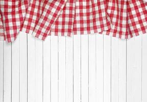 Red tablecloth on wooden table, top view photo