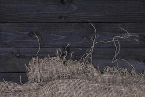 Dark wooden table background with burlap photo