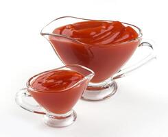 Ketchup in glass bowl isolated on white background photo