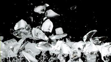 Pieces of ice rise up and fall down. On a black background. Filmed is slow motion 1000 fps. video