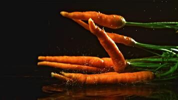 Fresh carrots fall on the table. Filmed is slow motion 1000 fps. High quality FullHD footage video