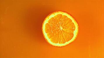 A round piece of orange falls into the orange juice with splashes. Macro background.Filmed on a high-speed camera at 1000 fps. video