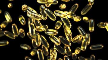 Omega 3 vitamin capsules rotate slowly in flight. On a black background. Filmed is slow motion 1000 fps. video