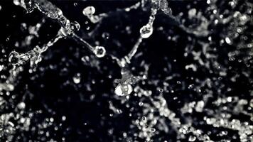 The movement of a drop of water in flight. Top view. On a black background. Filmed on a high-speed camera at 1000 fps. video