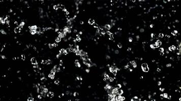 The movement of a drop of water in flight. Top view. On a black background. Filmed on a high-speed camera at 1000 fps. video