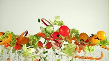 Pieces of chopped vegetables fly up and fall down. On a white background. Filmed on a high-speed camera at 1000 fps. video