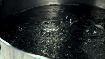 The pot boils water with air bubbles. Macro background. Filmed on a high-speed camera at 1000 fps. video