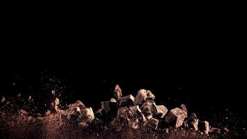 A pile of chocolate pieces rise to the top and fall down. On a black background. Filmed on a high-speed camera at 1000 fps. video