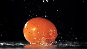 Water droplets fall on the rotating egg. On a black background. Filmed is slow motion 1000 fps. video