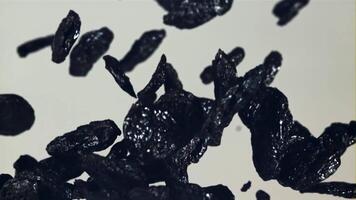 Prunes go up and down. On a blue background. Filmed is slow motion 1000 fps. video