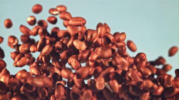 A pile of peanuts rises up and falls. On a blue background. Filmed is slow motion 1000 fps. video