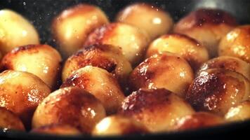 Potatoes are fried in a frying pan with splashes of oil and hot steam. Macro background. Filmed is slow motion 1000 fps. video