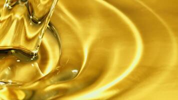 Olive oil pours a whirlpool. Macro background. The texture of olive oil. Filmed is slow motion 1000 fps. video