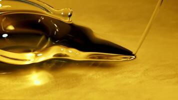 A jet of olive oil flows with waves and splashes. Macro background. Filmed on a high-speed camera at 1000 fps. video