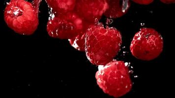Fresh raspberries fall underwater with bubbles. Filmed is slow motion 1000 fps. High quality FullHD footage video